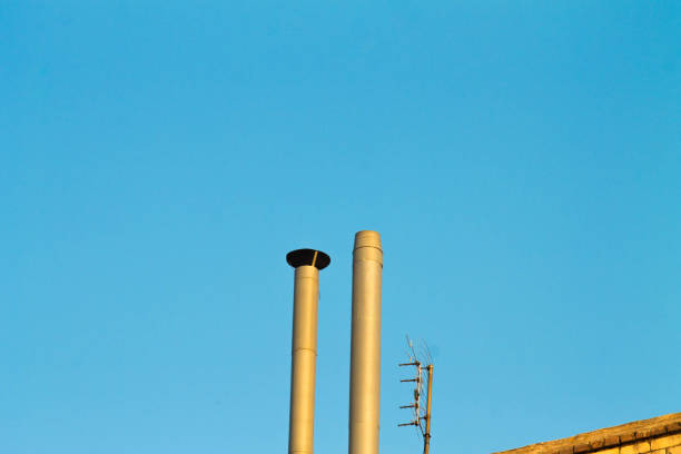 istock Pipe on the roof. Chimney. House with chimney 1070956318