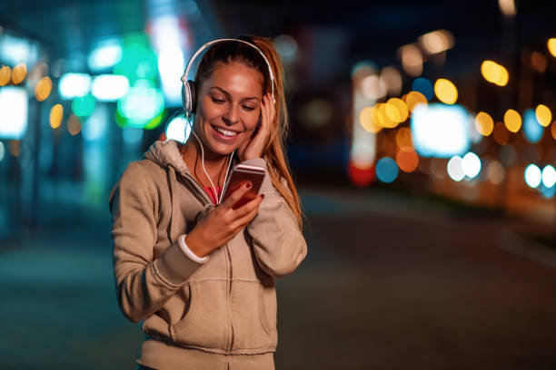 istock Young woman running at night 1070956326
