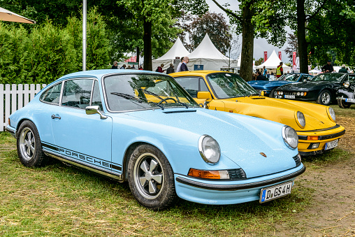 Porsche 911 Targa classic 1970s classic sports car front. This 1970s Porsche 911 has typical Porsche striping on the side and Fuchs alloy wheels. The car is on display during the 2017 Classic Days event at Schloss Dyck.