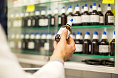 Pharmacist holding a medicine bottle in hand