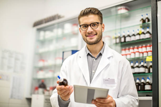 istock Smiling male pharmacist with digital tablet and medicine 1070960262