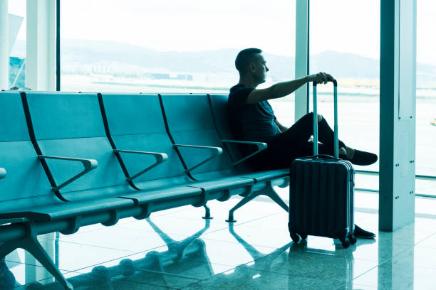 istock man waiting for his flight in an airport 1070960824