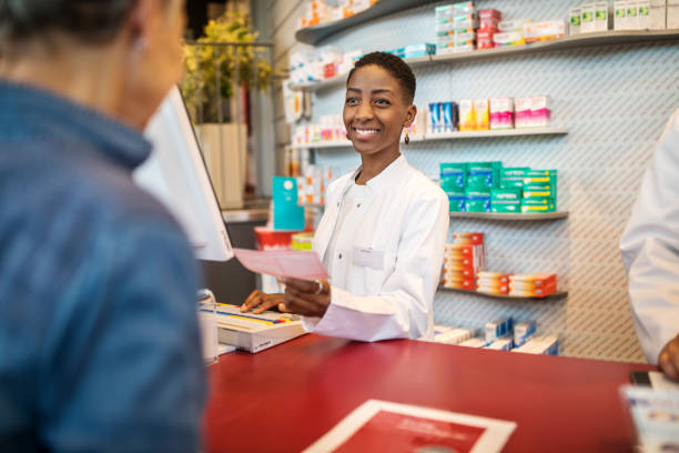 istock Female pharmacist assisting to customer in pharmacy 1070961000