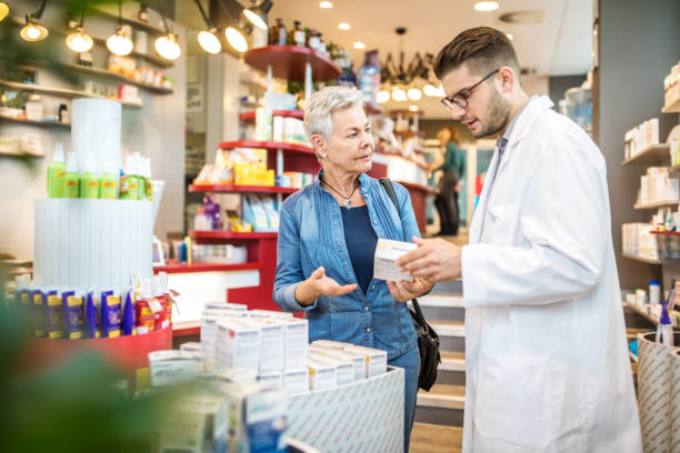 istock Chemist explaining medication to customer in drugstore 1070961448