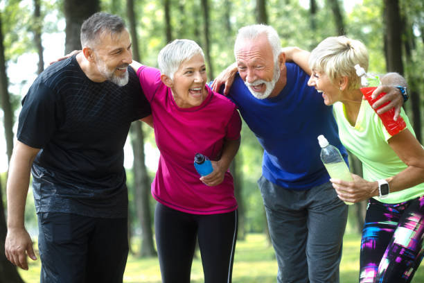 istock Senior people having a group hug while exercising outdoors 1070964928