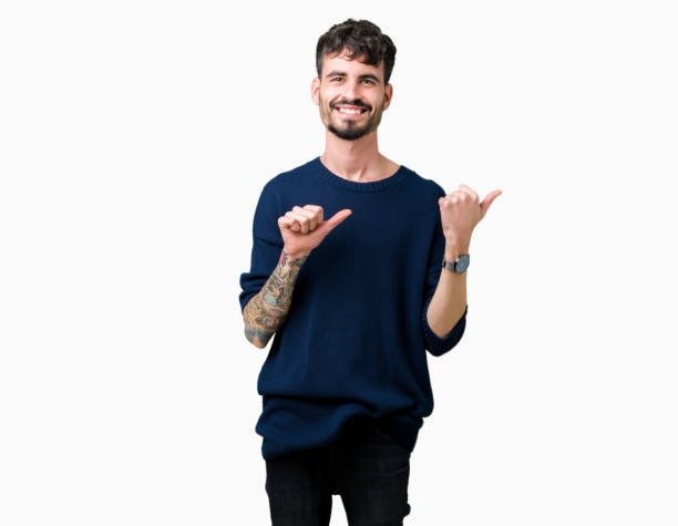 Young handsome man over isolated background Pointing to the back behind with hand and thumbs up, smiling confident Young handsome man over isolated background Pointing to the back behind with hand and thumbs up, smiling confident body adornment rear view young men men stock pictures, royalty-free photos & images