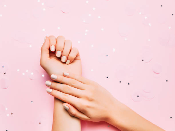 istock Beatiful female hands with stylish manicure on sparkling holiday background. 1070965200