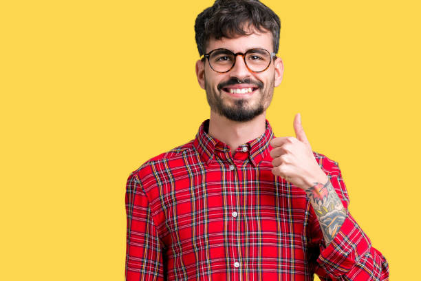 istock Young handsome man wearing glasses over isolated background confuse and wonder about question. Uncertain with doubt, thinking with hand on head. Pensive concept. 1070965350