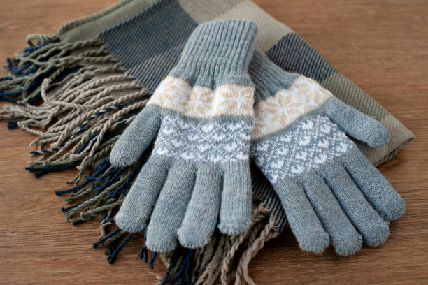 istock Gray gloves on a gray scarf. 1070967210