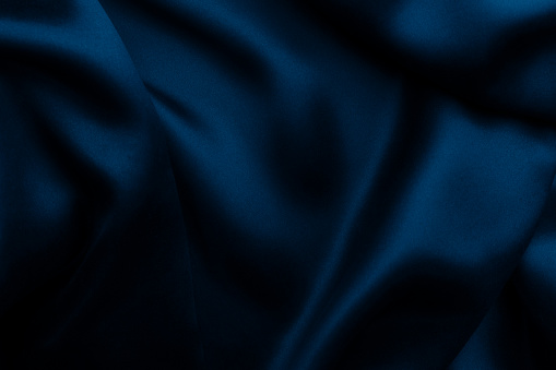 Elegant blue satin silk with waves, texture background