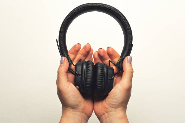 istock Close-up - black headphones in female hands 1070971134