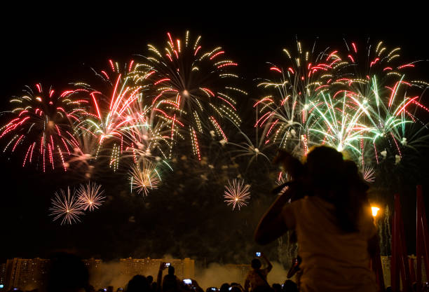 istock Viewers watch beautiful fireworks in the sky. 1070971442