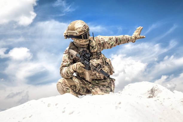 soldier in uniform standing and holding a gun