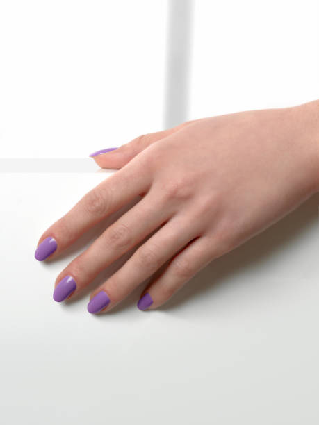 istock woman hand with violet nails manicure 1070971764
