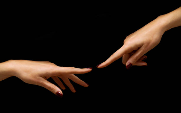 two woman hands with red nail polish on black background