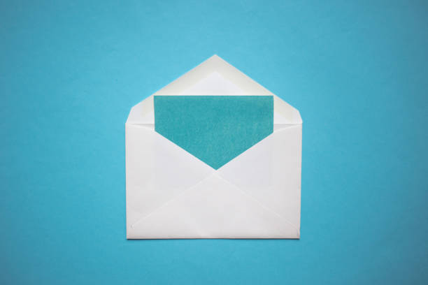 istock Christmas composition. Envelope with a blue card on blue background. Copy space 1070974410