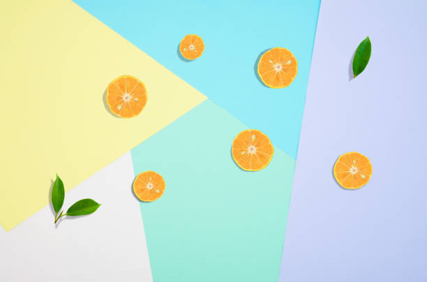 istock Top view Orange  fruit slice and green leaf   isolated on pastel color background 1070978400