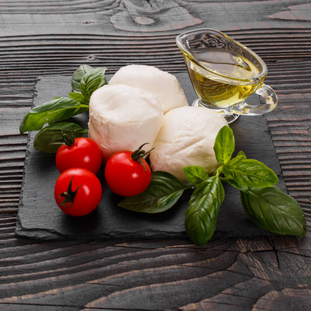 istock Mozzarella tomatoes and basil on a wooden rustic background 1070981382