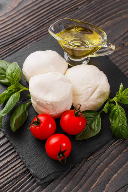 istock Mozzarella tomatoes and basil on a wooden rustic background 1070981394