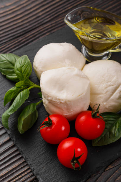 istock Mozzarella tomatoes and basil on a wooden rustic background 1070981428