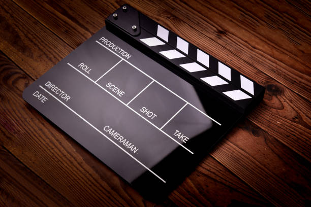 istock Movie clapper board on wooden background 1070984570
