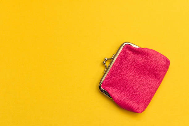 istock Pink wallet on yellow background . Close up. Top view 1070987524