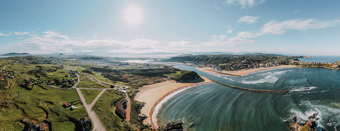 A coastal landscape showing the town of Suances in Cantabria, Spain.