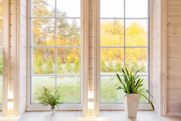 istock Bright photo studio interior with big window, high ceiling, white wooden floor 1070995030