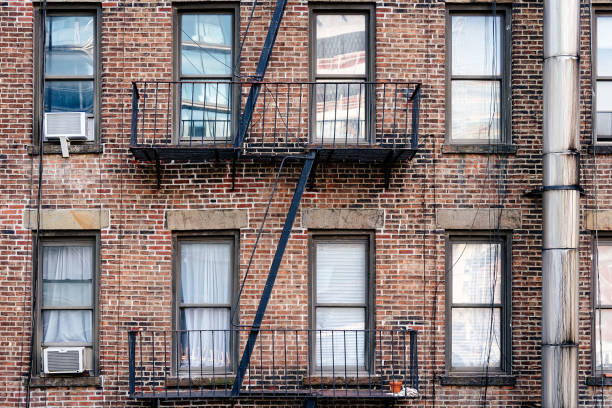 istock Old brick building with balconies and fire escape 1070998876