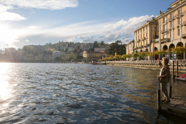 istock Man uses digital tablet on dock above lake 1071000370