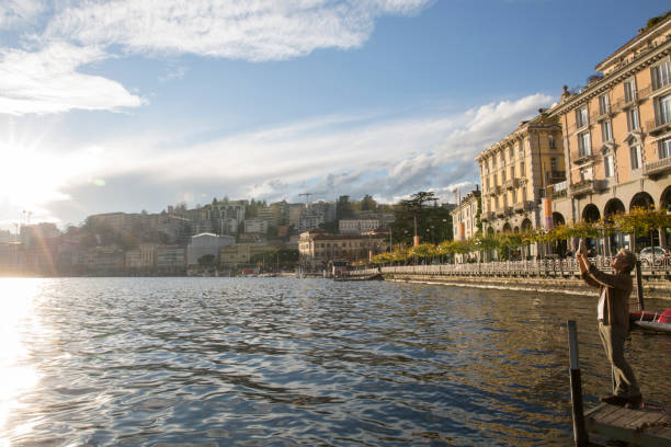 istock Man uses digital tablet on dock above lake 1071000434