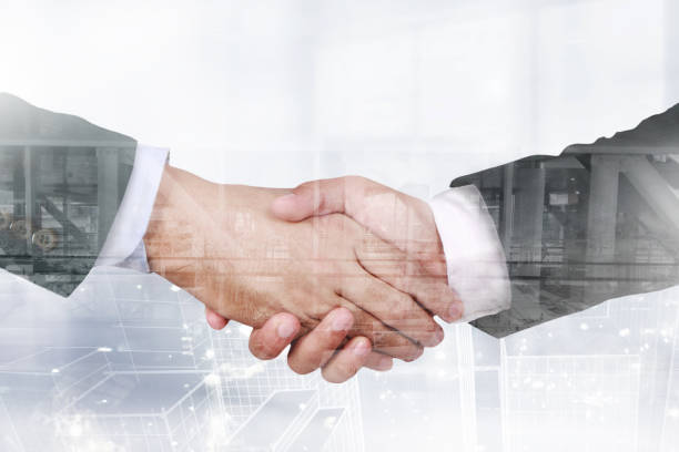 istock Double exposure image of two businessman shaking hand overlay with cityscape image 1071002196