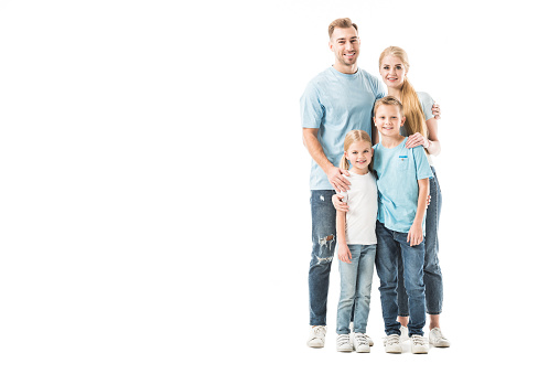 Cheerful family standing and hugging isolated on white