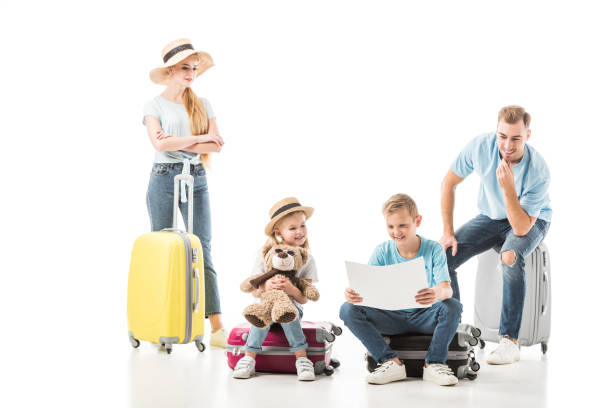 istock Happy family sitting on baggage and looking on map isolated on white 1071003910