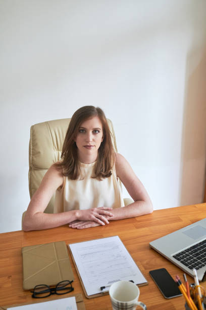 istock Modern young businesswoman sitting at table 1071004136