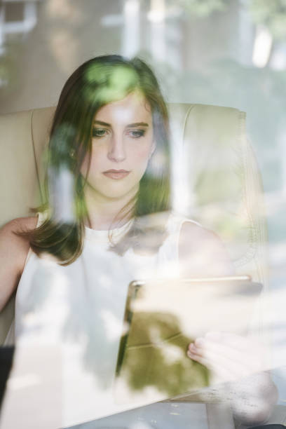 istock Young businesswoman watching tablet in office 1071004158