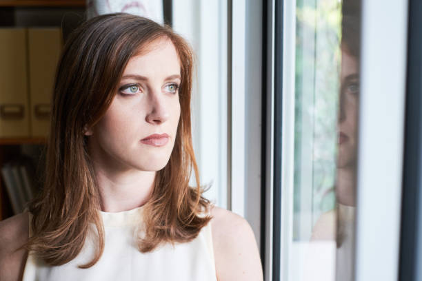 istock Pensive businesswoman looking away in window 1071004242