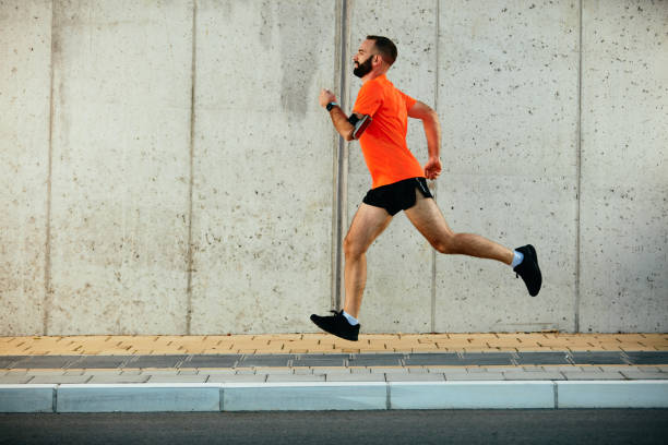 istock Young bearded man running on the street. 1071006566