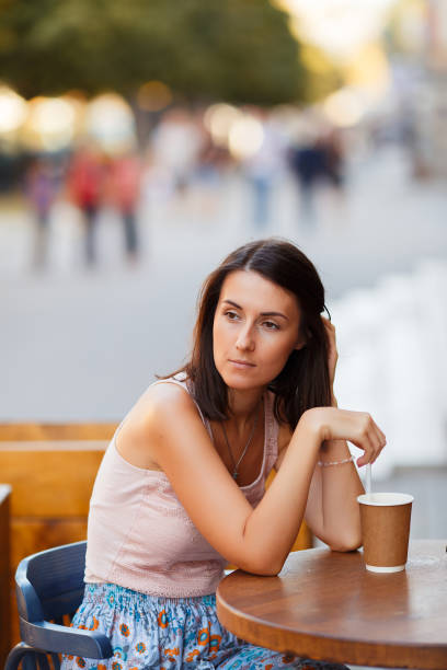 istock Beautiful Lady With A Coffee Sitting On A Summer Terrace 1071011314