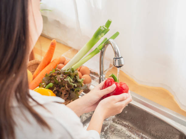 istock asian woman with fruit in the kitchen 1071011326
