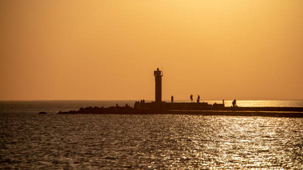 istock breakwater in the sea with red lighthouse at the end 1071016306