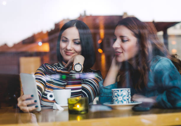 istock Smiling friends enjoying coffee together 1071016848