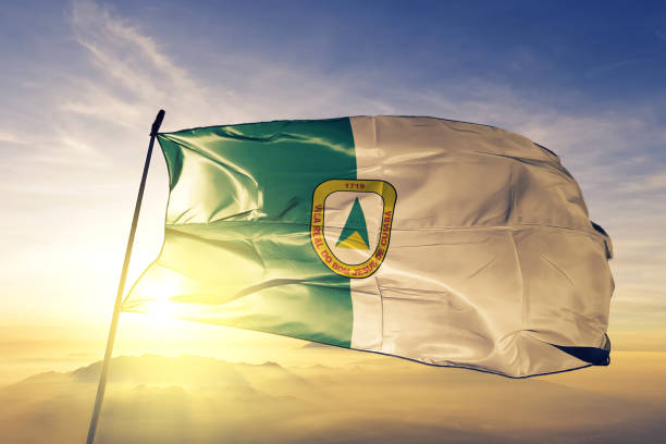 Cuiaba city of Brazil flag textile cloth fabric waving on the top sunrise mist fog Cuiaba city of Brazil flag on flagpole textile cloth fabric waving on the top sunrise mist fog cuiabá photos stock pictures, royalty-free photos & images