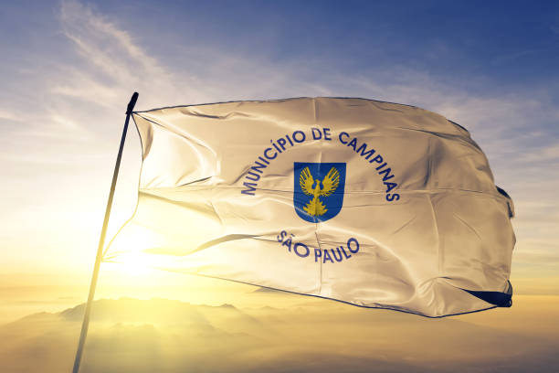 Campinas city of Brazil flag textile cloth fabric waving on the top sunrise mist fog Campinas city of Brazil flag on flagpole textile cloth fabric waving on the top sunrise mist fog campinas photos stock pictures, royalty-free photos & images