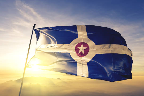 Indianapolis city capital of Indiana of United States flag textile cloth fabric waving on the top sunrise mist fog Indianapolis city capital of Indiana of United States flag on flagpole textile cloth fabric waving on the top sunrise mist fog seal of the state of indiana stock pictures, royalty-free photos & images