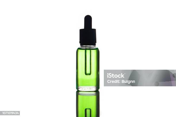 Blank Mock Up Advertising Of The Green Eliquid Ejuice In The Bottle Isolated On The White Background With Copy Space Stock Photo - Download Image Now