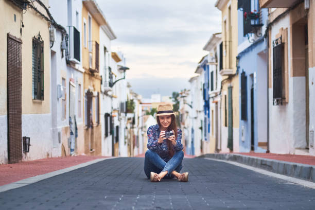 istock Young woman taking photos with old camera 1071020162