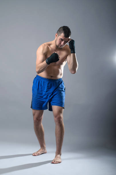 istock Portrait of kickboxer on a gray background. 1071022142