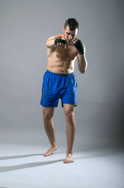 istock Portrait of kickboxer on a gray background. 1071022148