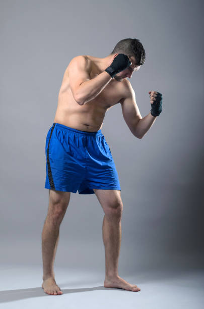 istock Portrait of kickboxer on a gray background. 1071022154